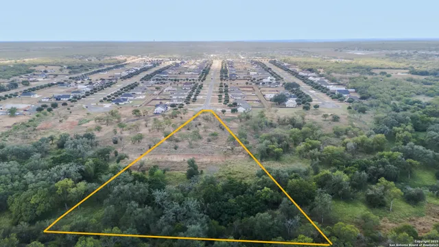an aerial view of beach and yard