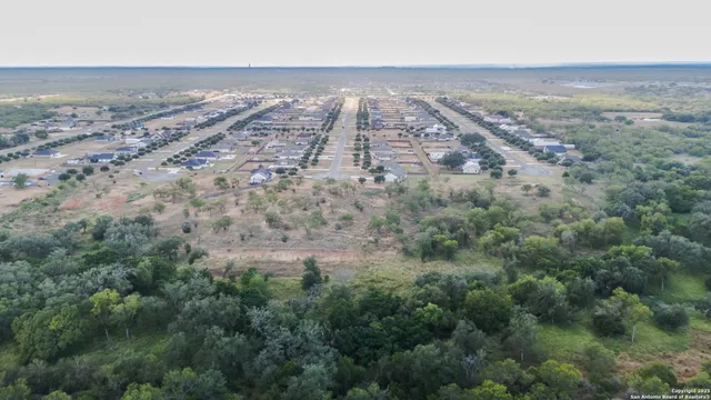 an aerial view of beach and yard