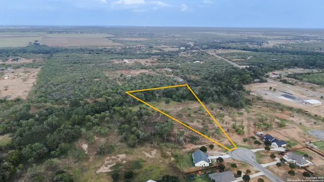 an aerial view of house with yard