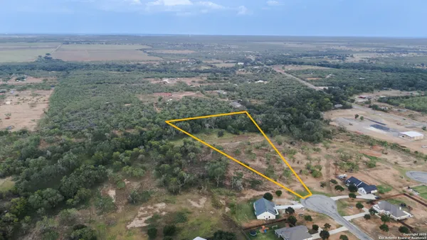 an aerial view of house with yard