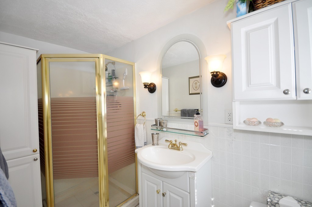 174 Hudson Road Stow, MA 01775 - Photo 16 of 29 a bathroom with a sink a mirror and shower