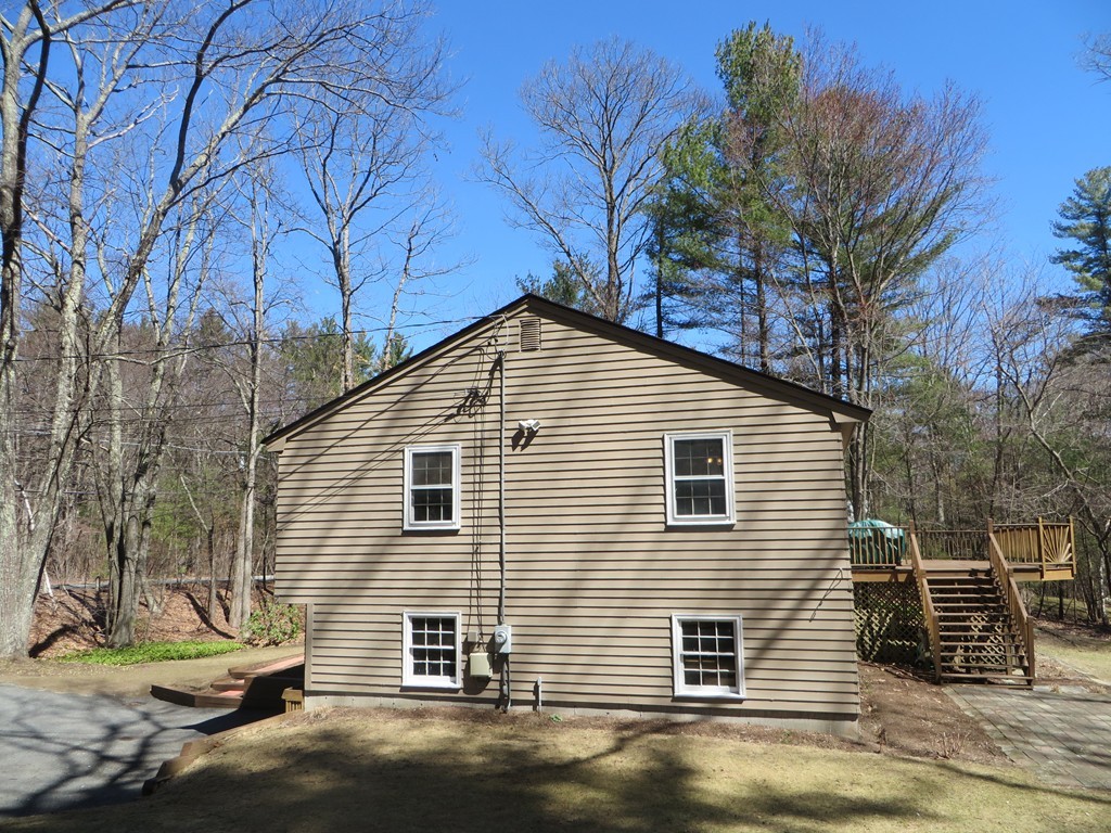 174 Hudson Road Stow, MA 01775 - Photo 26 of 29 a view of a house with a yard