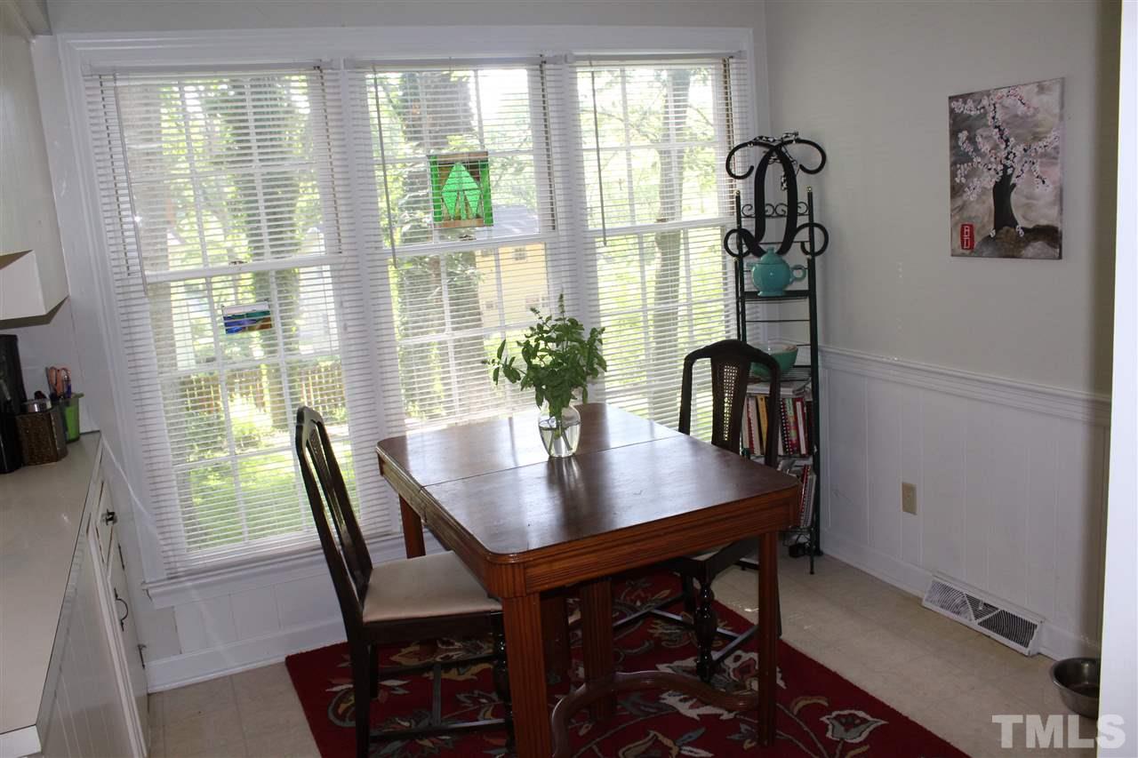 4204 Redington Drive Raleigh, NC 27609 - Photo 6 of 10 a view of a dining room with furniture and a potted plant