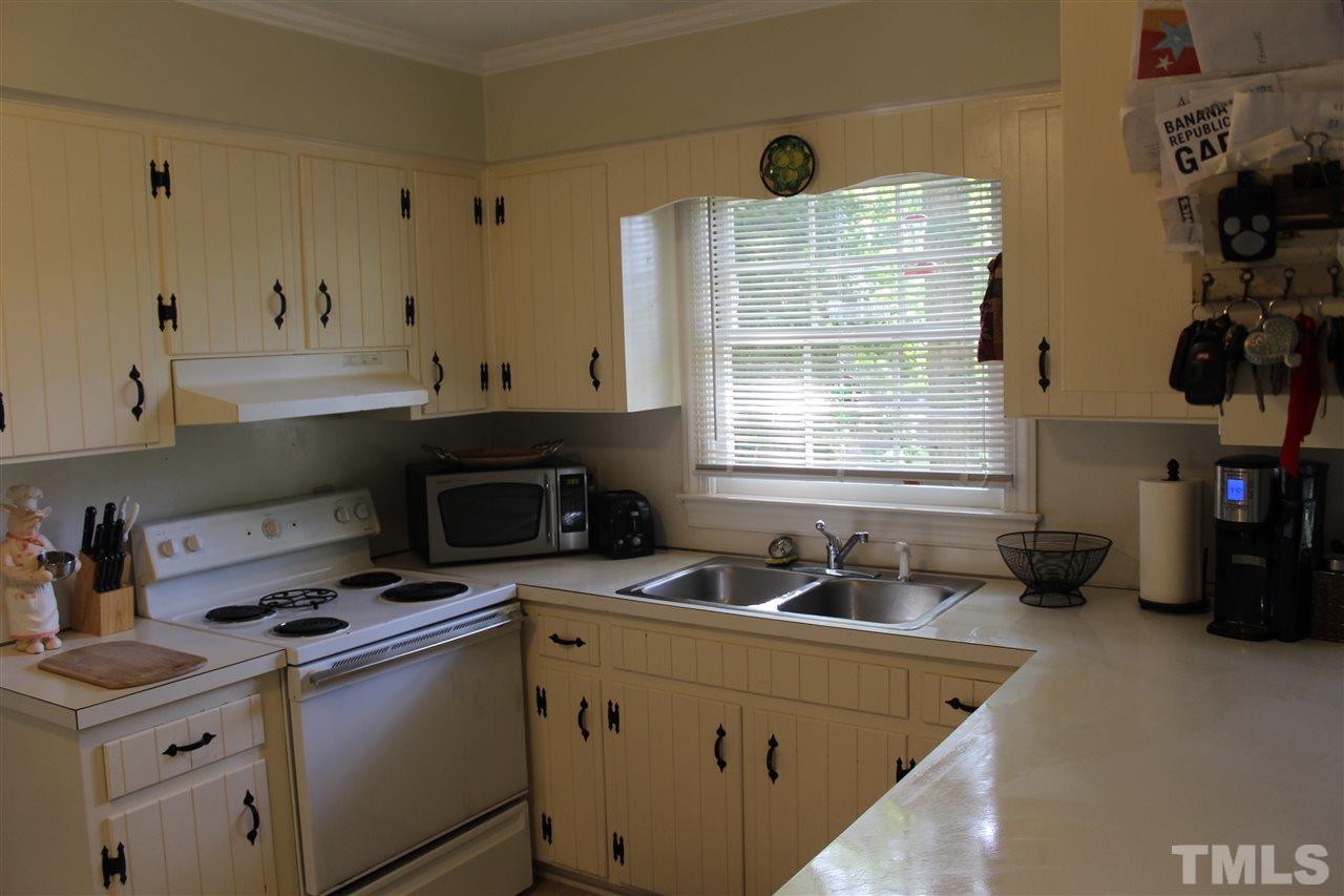 4204 Redington Drive Raleigh, NC 27609 - Photo 7 of 10 a kitchen with a sink a stove and cabinets