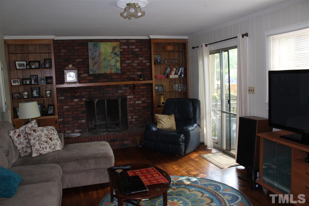 4204 Redington Drive Raleigh, NC 27609 - Photo 8 of 10 a living room with furniture and a flat screen tv