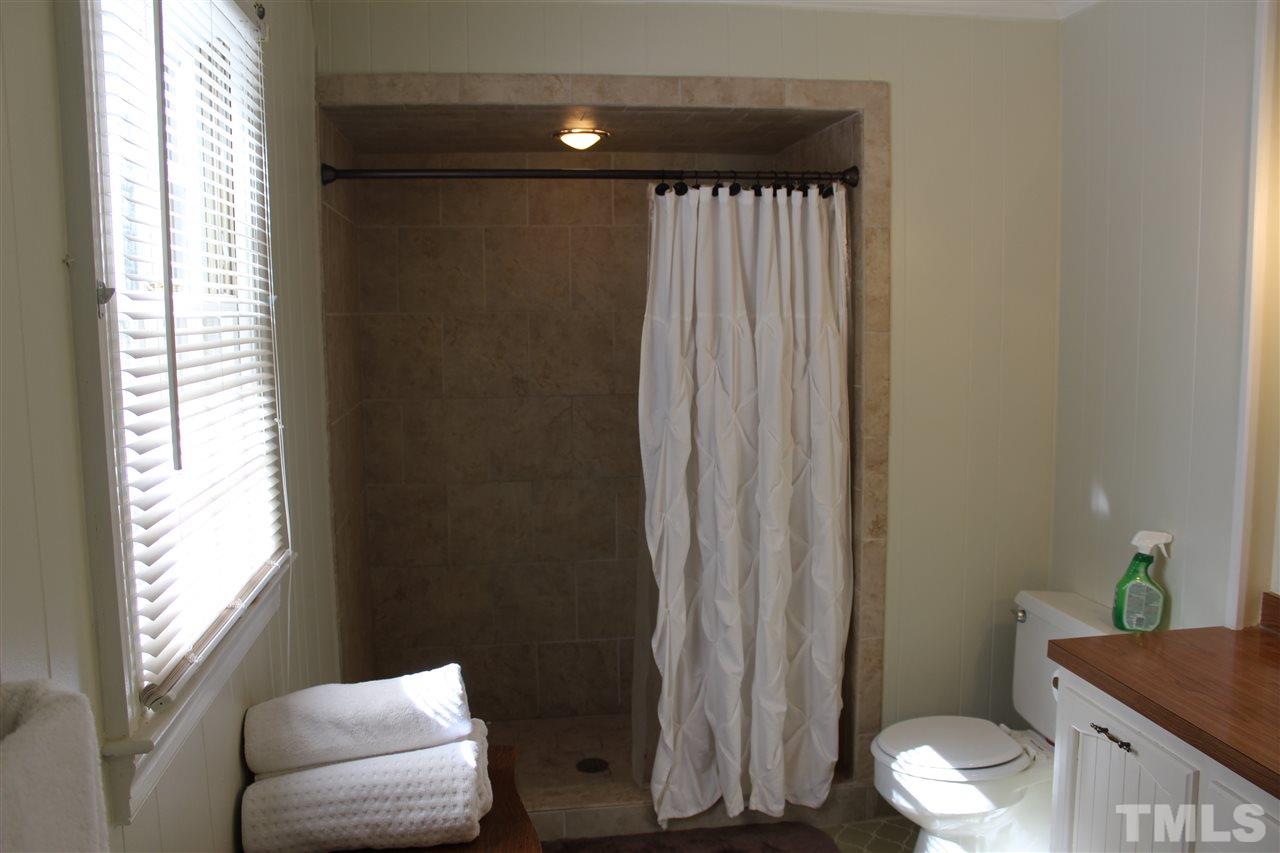 4204 Redington Drive Raleigh, NC 27609 - Photo 10 of 10 a bathroom with a toilet and a shower curtain