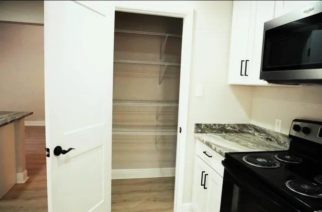 a kitchen with a stove and a microwave