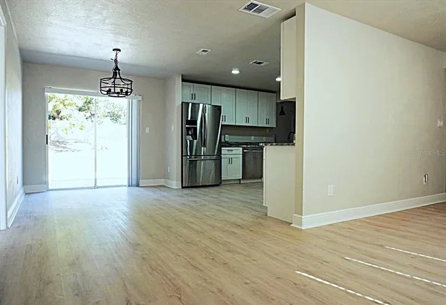 a kitchen with white cabinets stainless steel appliances and sink