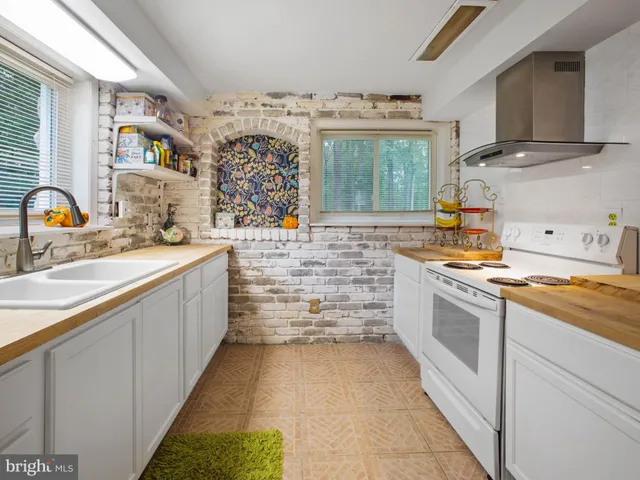 a kitchen with stainless steel appliances a sink stove and cabinets