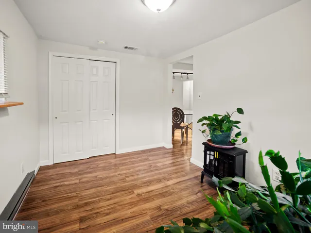 a workspace with wooden floor and a potted plant