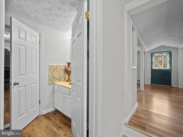 a view of an entryway with wooden floor and windows