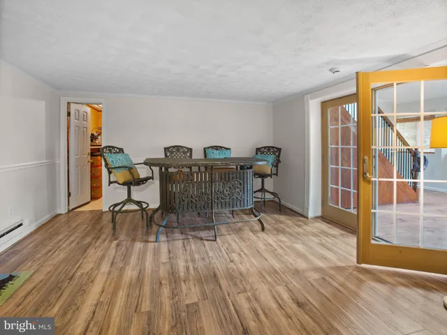 a workspace room with wooden floor a table and chairs