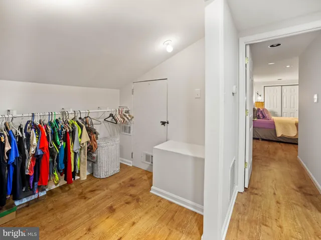 a view of walk in closet with clothes