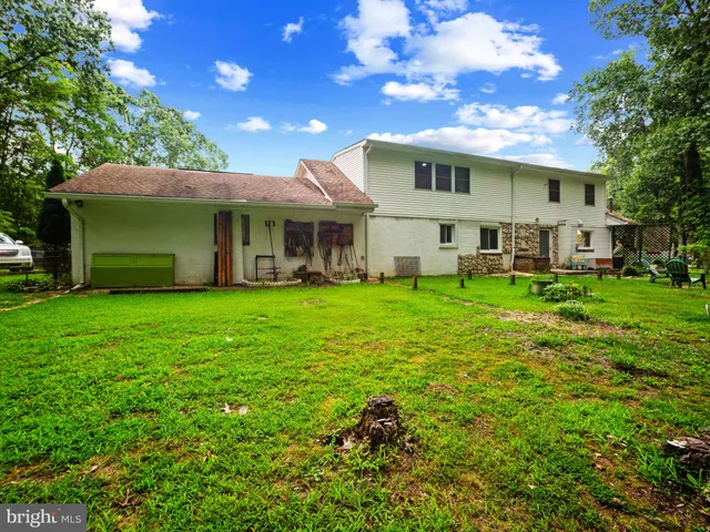 a view of a house with a yard porch and sitting area