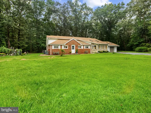 a big house with a big yard and large trees
