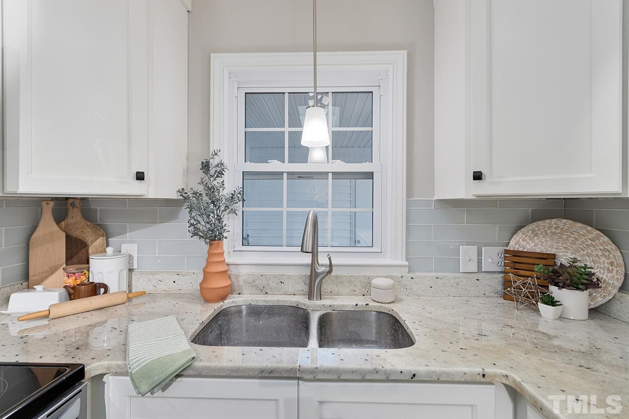 3915 Butler Boulevard Raleigh, NC 27604 - Photo 10 of 30 a kitchen with granite countertop a sink and a stove