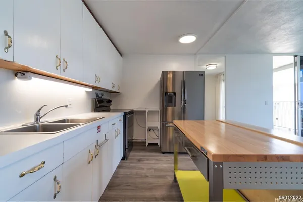 a large kitchen with kitchen island a sink stainless steel appliances and cabinets