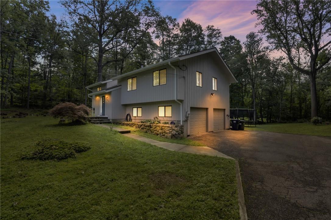 a front view of a house with yard and green space