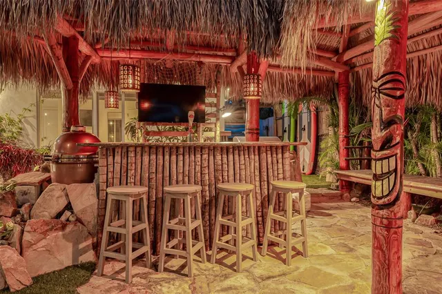 a table and chairs with potted plants