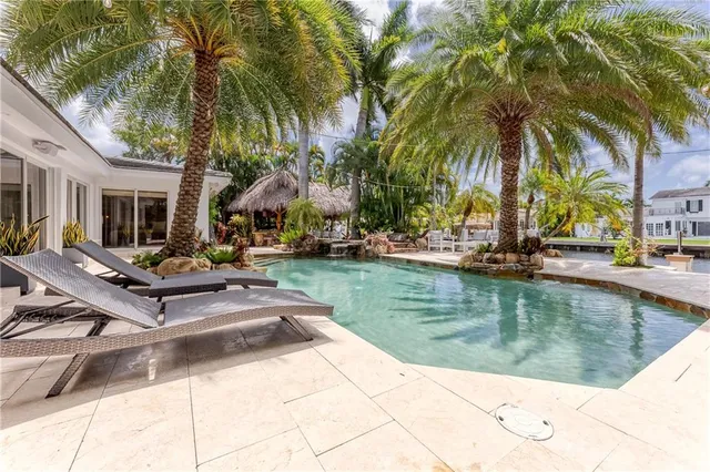 a view of a house with backyard outdoor seating area and barbeque oven