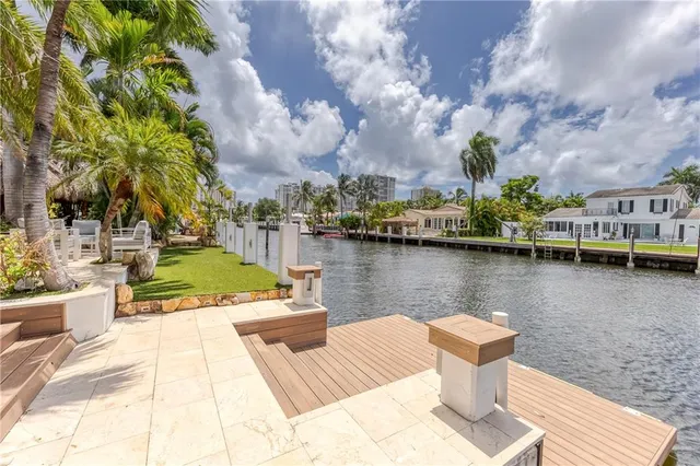 a living room with furniture a large window and a flat screen tv