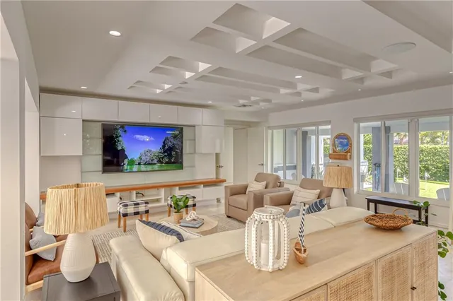 a large kitchen with kitchen island a large window cabinets and stainless steel appliances