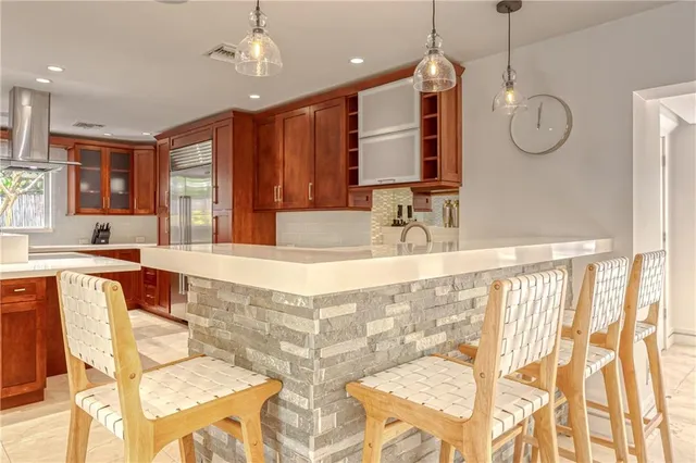 a living room with fireplace furniture and a large window