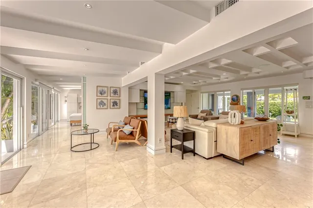 a living room with furniture a dining table and chairs