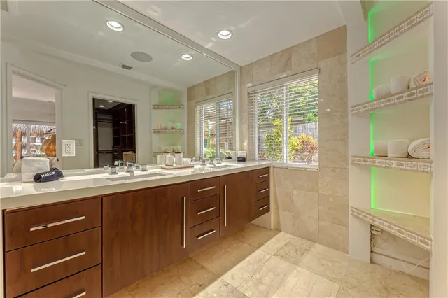 a white toilet sitting next to a bathroom sink