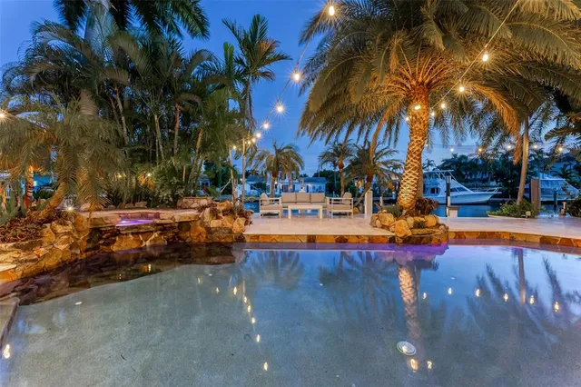 a swimming pool view with a outdoor seating