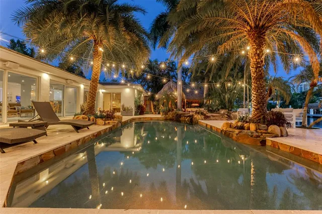 a swimming pool view with a outdoor seating