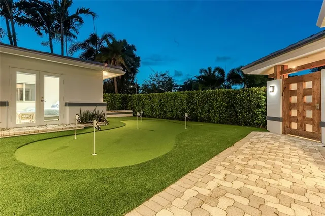 a backyard of a house with barbeque oven table and chairs