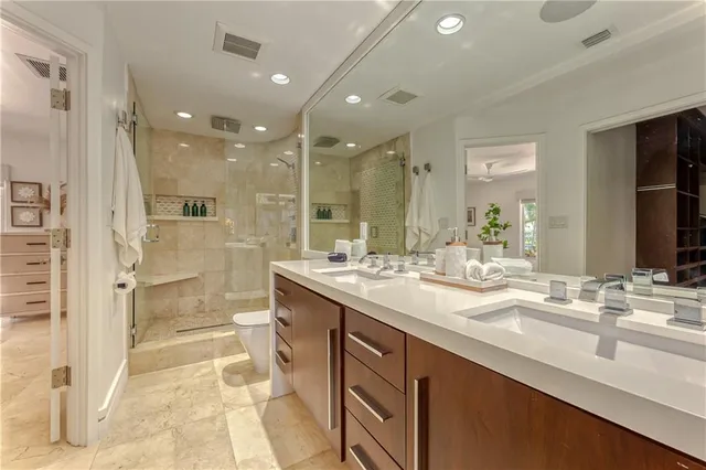 a bathroom with a granite countertop sink mirror and a bath tub