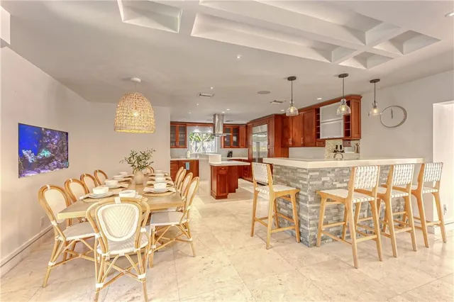 a view of a dining room with furniture and a large window