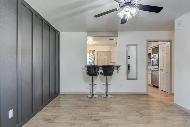 a view of entryway with a chandelier fan and a livingroom