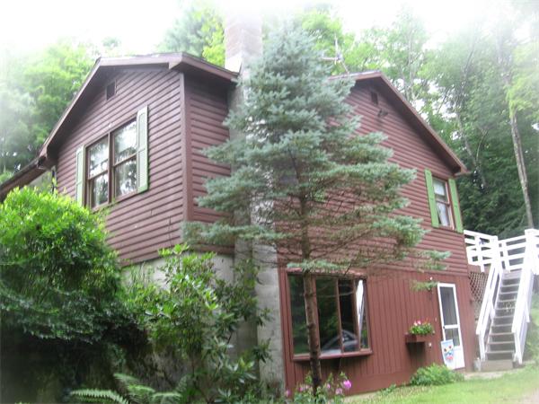 44 Old Main Road Worthington, MA 01098 - Photo 1 of 15 a front view of a house with garden