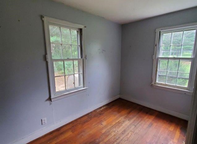 45 School House Hl Road Raphine, VA 24472 - Photo 8 of 14 an empty room with wooden floor and windows
