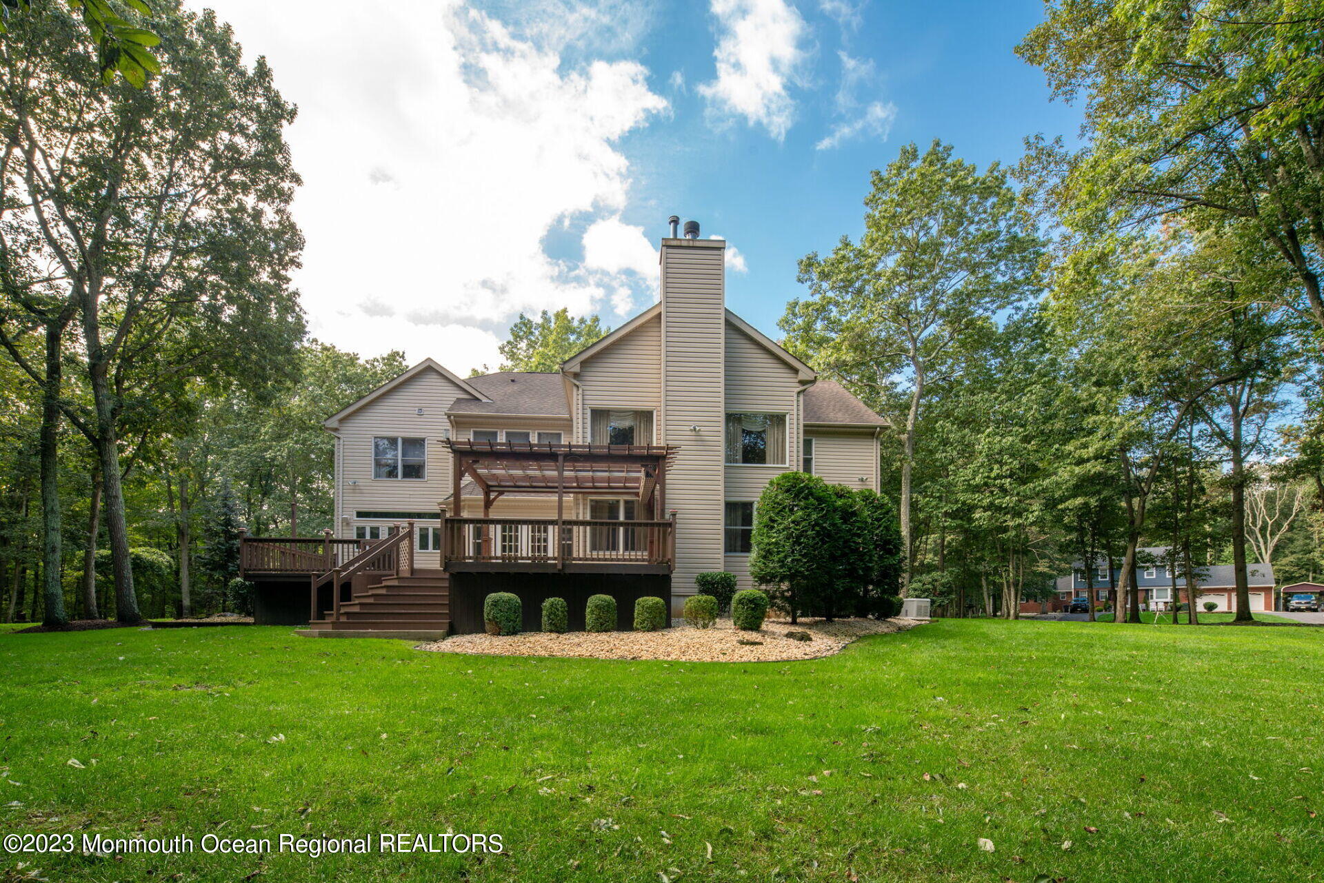 81 Agress Road Millstone Township, NJ 08535 - Photo 31 of 35 a front view of a house with a garden and trees