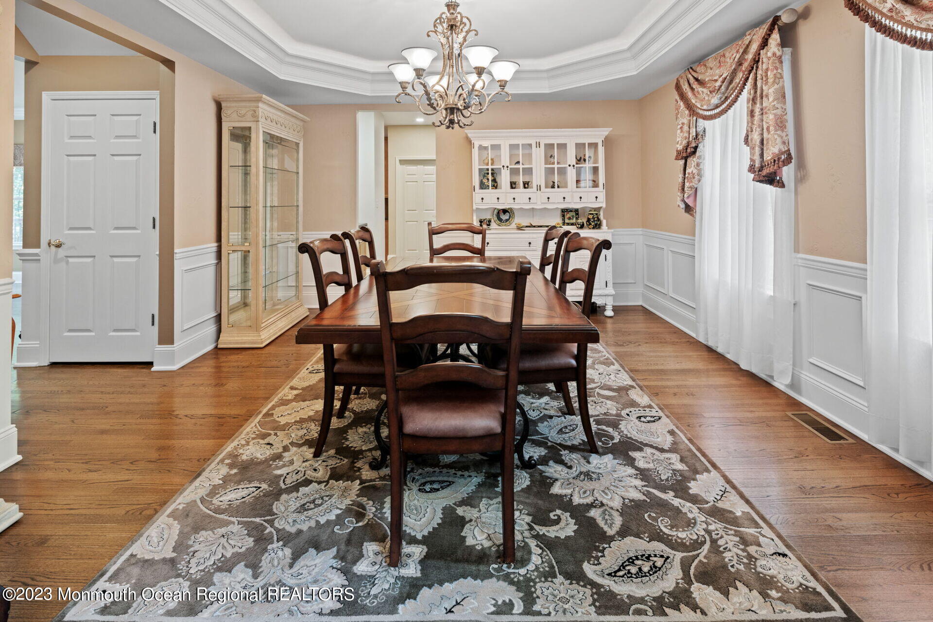 81 Agress Road Millstone Township, NJ 08535 - Photo 6 of 35 a dining room with furniture a chandelier and wooden floor