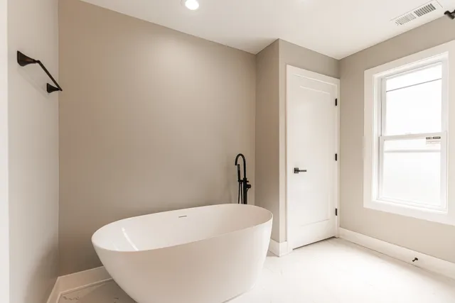 a white bath tub sitting in a bathroom