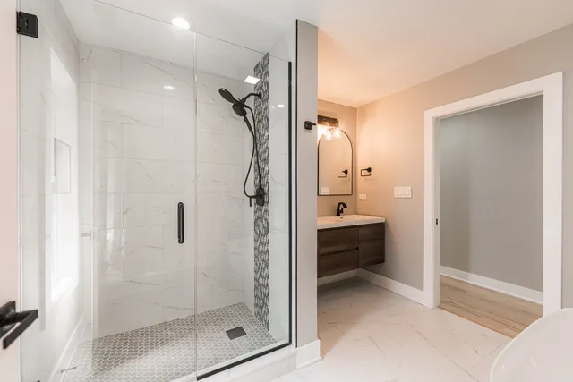 a bathroom with a glass shower door