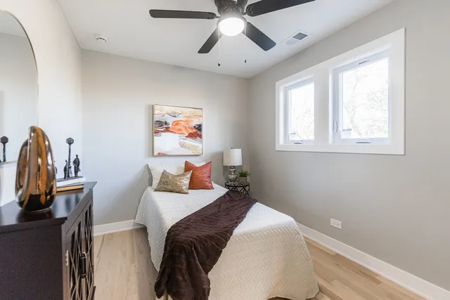 a bedroom with a bed and a chandelier