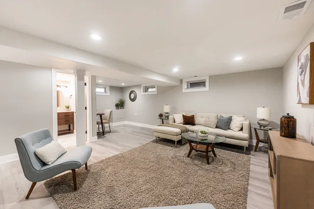 a living room with furniture and a wooden floor