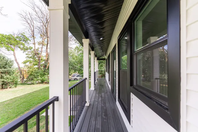 a view of a balcony with wooden floor
