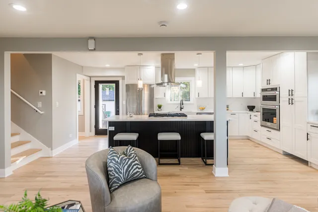 a living room with furniture and kitchen view
