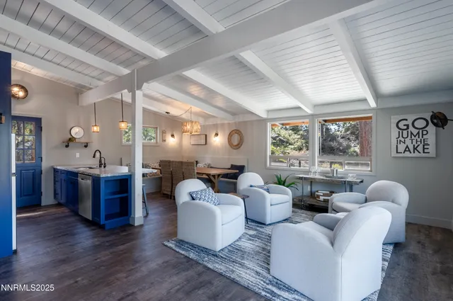 a living room with furniture and large windows