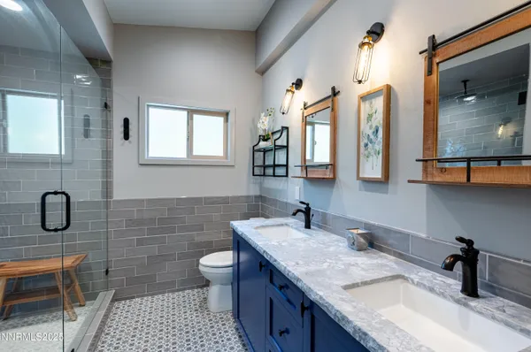 a kitchen with stainless steel appliances granite countertop a stove a sink dishwasher a dining table and chairs with wooden floor