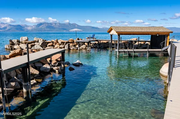 a view of a balcony with dining table and chairs with wooden floor