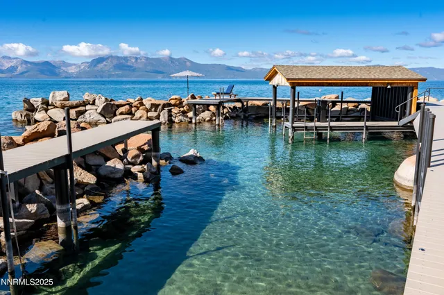 a view of a balcony with dining table and chairs with wooden floor