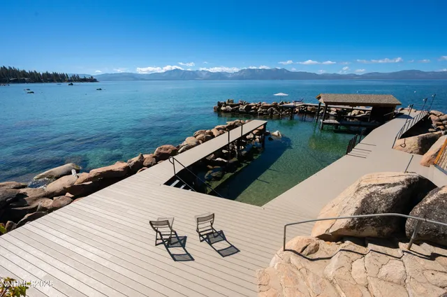 a front view of a house with a yard and potted plants